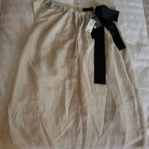 Evening blouse semi shiny cream color w/black bow